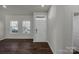 Bright living room with dark hardwood floors and neutral walls at 638 Sagecroft Ln, Indian Trail, NC 28079