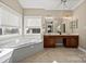 Bathroom with a large soaking tub and double vanity at 7005 Shadow Rock Ct, Matthews, NC 28104