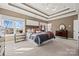 Bright bedroom with a wooden bed frame and neutral decor at 7005 Shadow Rock Ct, Matthews, NC 28104