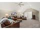 Bonus room with leather sectional sofa and game table at 7005 Shadow Rock Ct, Matthews, NC 28104