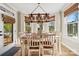 Bright breakfast nook features a table for six and access to the backyard at 7005 Shadow Rock Ct, Matthews, NC 28104