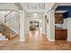 Two-story entryway with hardwood floors, staircase, and built-in cabinetry at 7005 Shadow Rock Ct, Matthews, NC 28104