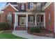 Brick front porch with white columns and railing at 7005 Shadow Rock Ct, Matthews, NC 28104