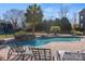 Resort-style pool with lounge chairs and landscaping at 7005 Shadow Rock Ct, Matthews, NC 28104