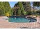 Inviting in-ground pool with a stone water feature at 7005 Shadow Rock Ct, Matthews, NC 28104