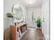 Bright and airy entryway with a large mirror and a console table at 7324 Swans Run Rd, Charlotte, NC 28226