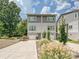 Contemporary gray two-story home with attached garage and neatly landscaped front at 7324 Swans Run Rd, Charlotte, NC 28226