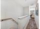 Upstairs hallway with hardwood floors and access to bedrooms at 7324 Swans Run Rd, Charlotte, NC 28226