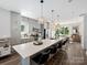 Modern kitchen with gray cabinets, large island, and stainless steel appliances at 7324 Swans Run Rd, Charlotte, NC 28226