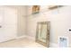 Bright laundry room with shelving and tiled floor at 7673 Bainbridge Rd, Sherrills Ford, NC 28673