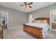 Bedroom with wooden bed frame and access to bathroom at 7734 Garnkirk Dr, Huntersville, NC 28078