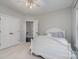 Spacious bedroom with ceiling fan and double doors at 7734 Garnkirk Dr, Huntersville, NC 28078