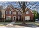 Brick home with a two-car garage and manicured lawn at 7734 Garnkirk Dr, Huntersville, NC 28078