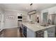 Large kitchen island with wine cooler and granite countertop at 7734 Garnkirk Dr, Huntersville, NC 28078