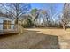 Large backyard with wooden deck and mature trees at 7933 Cherry Point Dr, Denver, NC 28037