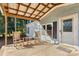 Covered porch with rocking chairs and a small side table at 7933 Cherry Point Dr, Denver, NC 28037