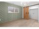 Bedroom with green accent wall, wood barn door, and window at 902 N Mountain St, Cherryville, NC 28021