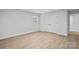 Well-lit bedroom featuring wood-look floors and a closet at 902 N Mountain St, Cherryville, NC 28021