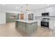 Modern kitchen with island, stainless steel appliances, and white cabinets at 902 N Mountain St, Cherryville, NC 28021