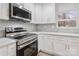 Modern kitchen with white cabinets and stainless steel appliances at 902 N Mountain St, Cherryville, NC 28021