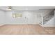 Living room with hardwood floors and a staircase with an iron railing at 902 N Mountain St, Cherryville, NC 28021