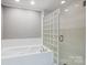 Bathroom with a large soaking tub and glass block shower at 9435 Squirrel Hollow Ln, Charlotte, NC 28720