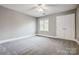 Spacious bedroom with neutral carpeting and double-door closet at 9435 Squirrel Hollow Ln, Charlotte, NC 28720