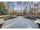 Large deck with wooden benches, offering a relaxing pool view at 9435 Squirrel Hollow Ln, Charlotte, NC 28720