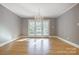 Sunlit dining room with hardwood floors and French doors leading to a deck at 9435 Squirrel Hollow Ln, Charlotte, NC 28720