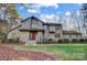 House exterior showcasing a stone facade and manicured lawn at 9435 Squirrel Hollow Ln, Charlotte, NC 28720