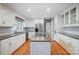 Spacious kitchen with granite island, white cabinets, and hardwood floors at 9435 Squirrel Hollow Ln, Charlotte, NC 28720