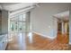 Open living area with hardwood floors and large windows at 9435 Squirrel Hollow Ln, Charlotte, NC 28720