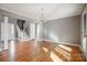 Bright living room with hardwood floors and a view of the staircase at 9435 Squirrel Hollow Ln, Charlotte, NC 28720