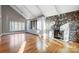 Living room with vaulted ceiling, stone fireplace, and hardwood floors at 9435 Squirrel Hollow Ln, Charlotte, NC 28720