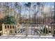 Elevated deck overlooks a large in-ground pool, surrounded by trees at 9435 Squirrel Hollow Ln, Charlotte, NC 28720