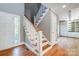 Elegant staircase with wood treads and white railings at 9435 Squirrel Hollow Ln, Charlotte, NC 28720