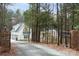 Long driveway leading to a white farmhouse at 1011 Three Lakes Trl, Waxhaw, NC 28173