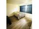 Cozy bedroom with hardwood floors and patterned bedding at 1016 Patricia Ave, Harrisburg, NC 28075