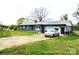 Ranch home with gray exterior, attached garage, and driveway at 1016 Patricia Ave, Harrisburg, NC 28075