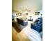 Spacious living room features hardwood floors and comfy leather furniture at 1016 Patricia Ave, Harrisburg, NC 28075