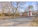 House with a driveway and large yard, surrounded by trees at 1028 White Ln, Gastonia, NC 28052