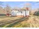White house with red brick base, deck, and yard at 1028 White Ln, Gastonia, NC 28052
