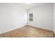 Simple bedroom with light wood flooring and a window overlooking the backyard at 103 Fairview St, Mount Holly, NC 28120