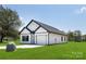 Modern farmhouse exterior with white siding, black accents, and a two-car garage at 103 Fairview St, Mount Holly, NC 28120