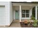 Inviting front porch with light teal door and white columns at 110 Nat Barber Ave, Gastonia, NC 28052