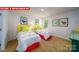 Bright bedroom featuring two beds with yellow headboards and colorful decor at 11127 Cardinal Creek Ave, Charlotte, NC 28215