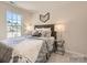 Bedroom with window and gray bedding at 113 Mountain Bridge Way, Statesville, NC 28625