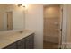 Bathroom with double sinks and vanity, a glass-enclosed shower, and coordinated fixtures and bright lights at 1136 Yellow Springs Dr, Huntersville, NC 28078