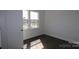 Bright bedroom featuring hardwood floors and a window with neighborhood views at 1136 Yellow Springs Dr, Huntersville, NC 28078