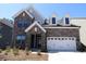 Charming two-story home with a beautiful stone facade and a white garage door, offering a blend of modern and traditional design at 1136 Yellow Springs Dr, Huntersville, NC 28078